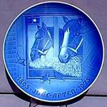 A blue plate with horses on it

Description automatically generated