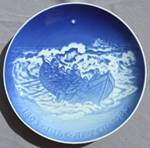 A blue and white plate with a ship in the water

Description automatically generated